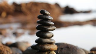 Stones stacked above each other near a lake