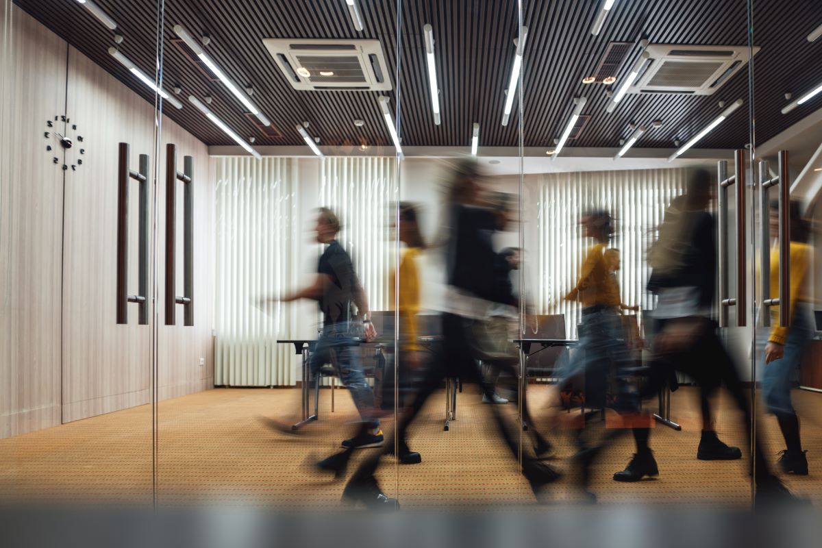 people walking through an office building