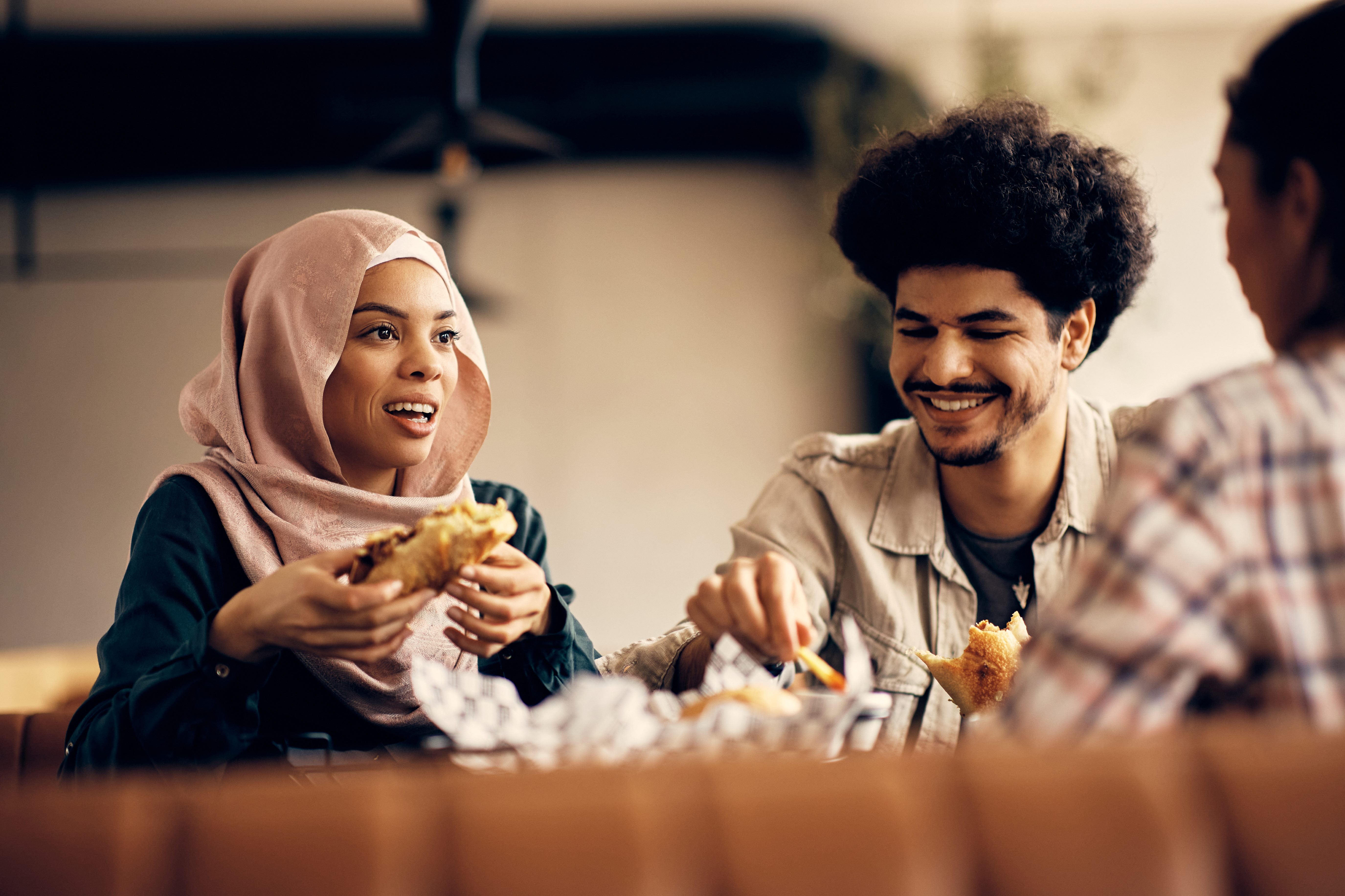 A woman talking to a group of friends while eating together